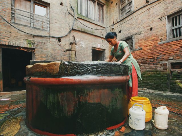 Women drawing water from well